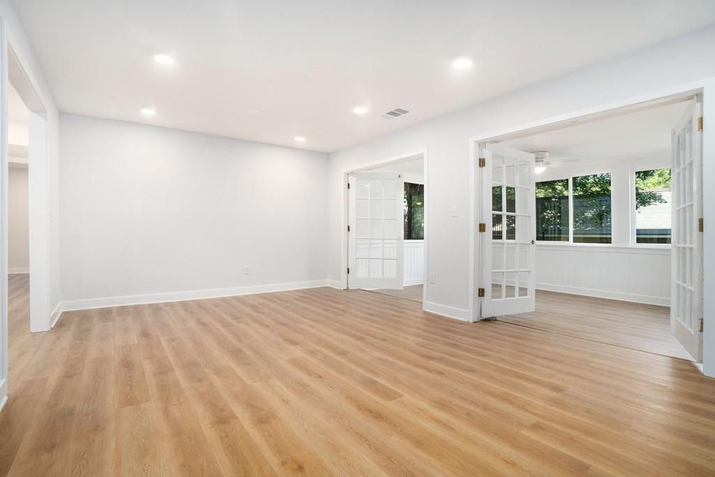 46 La Rue Place Northwest Atlanta, GA 30327 - Photo 7 of 28 an empty room with wooden floor and windows