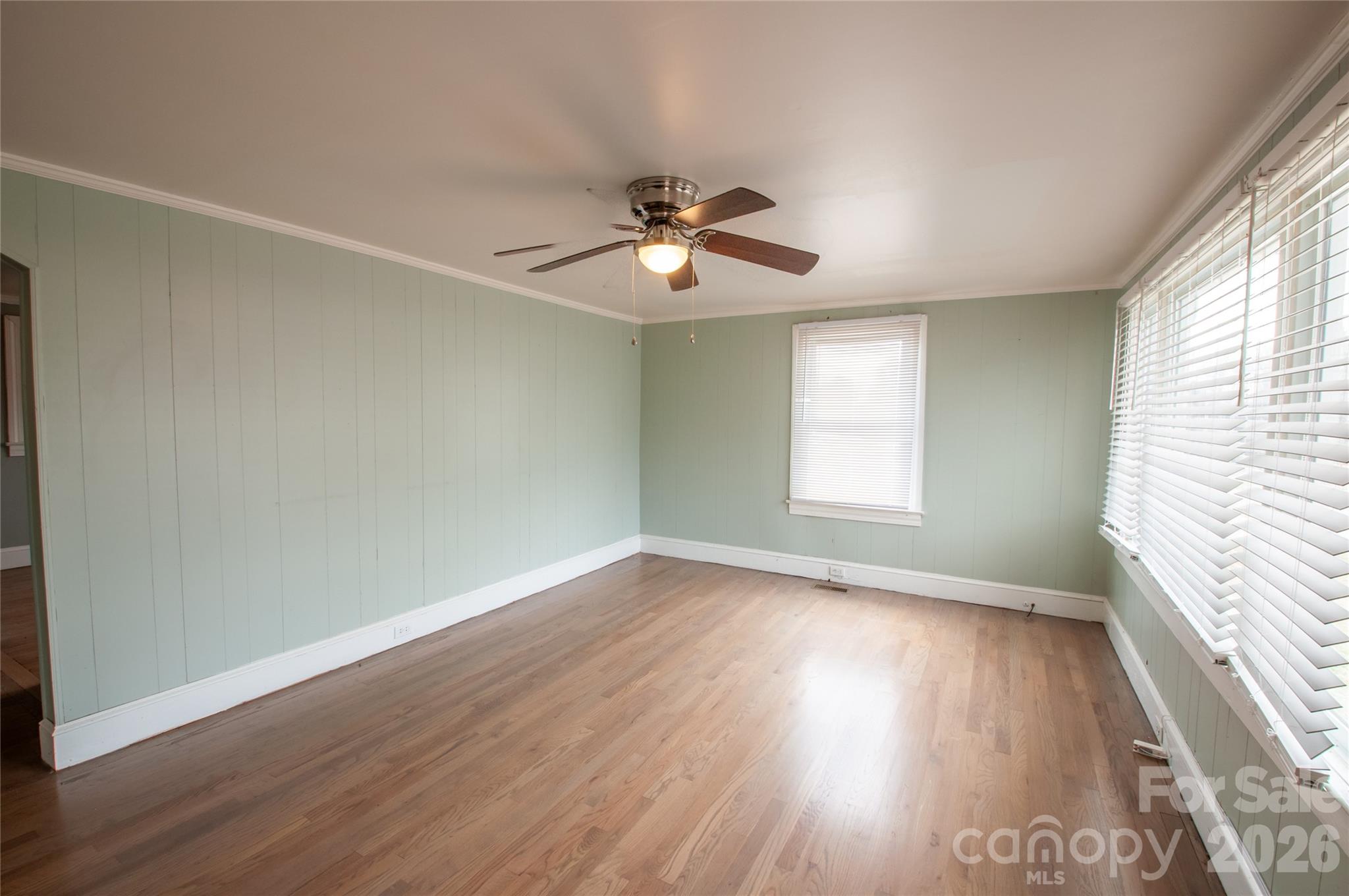 127 Bristol Road Statesville, NC 28677 - Photo 2 of 10 an empty room with wooden floor and windows