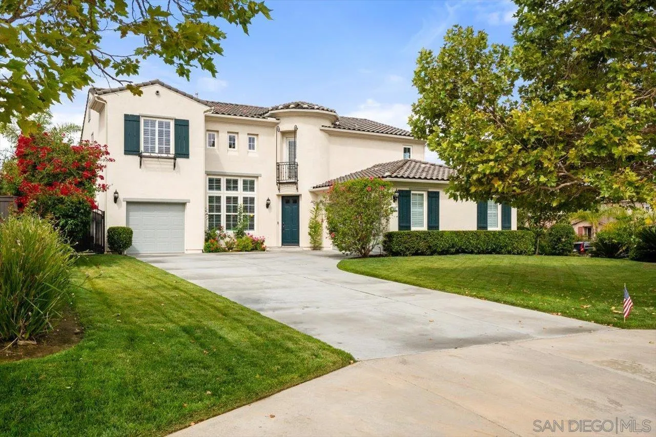 565 Hidden Trails Road Escondido, CA 92027 - Photo 1 of 52 a front view of a house with a yard and garage