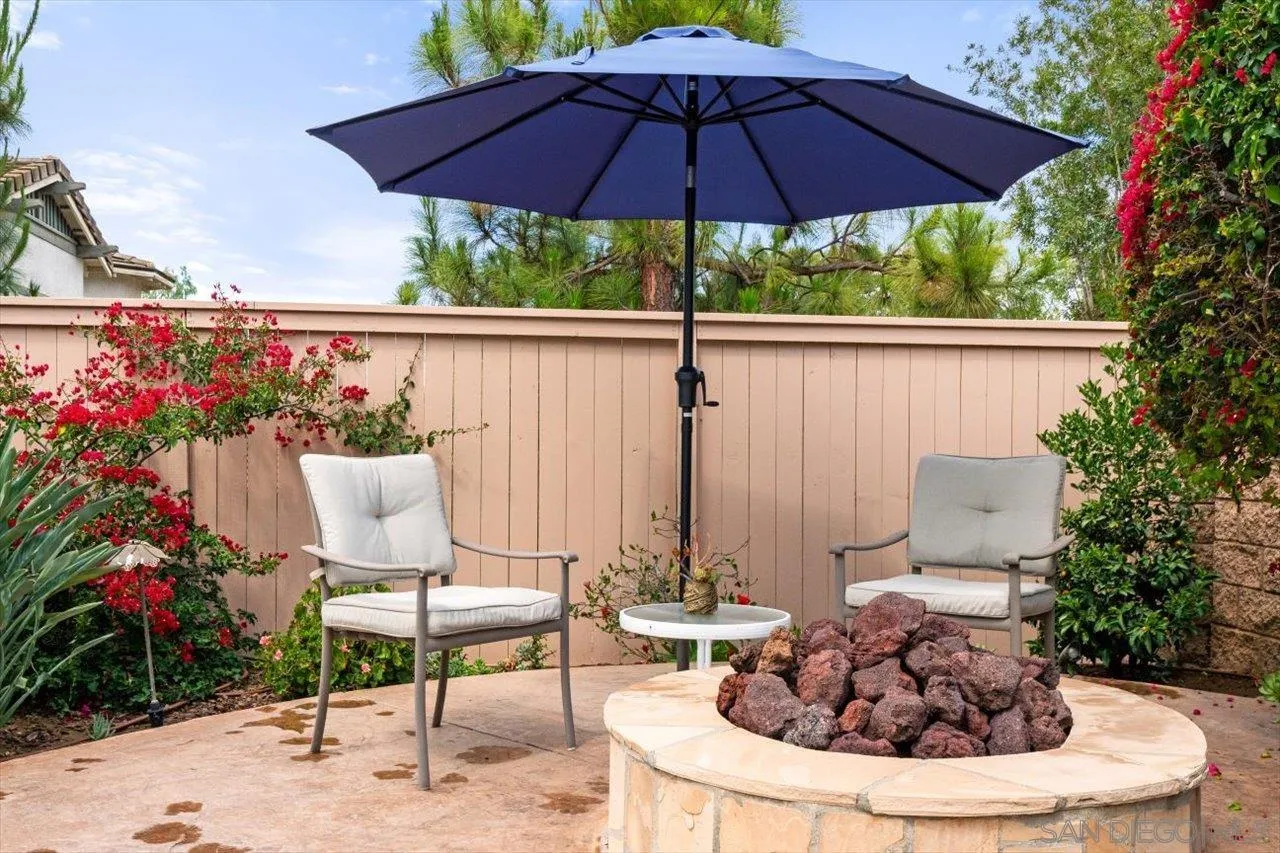 565 Hidden Trails Road Escondido, CA 92027 - Photo 14 of 52 a view of a chair and tables in the backyard