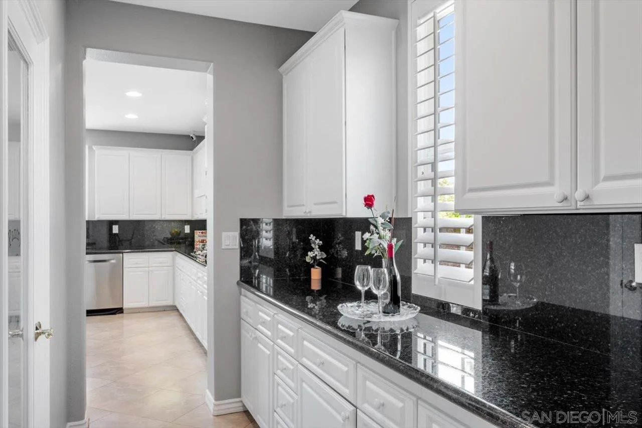 565 Hidden Trails Road Escondido, CA 92027 - Photo 18 of 52 a kitchen with sink and cabinets