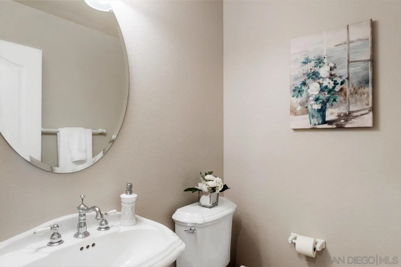 565 Hidden Trails Road Escondido, CA 92027 - Photo 23 of 52 a bathroom with a sink mirror and vanity