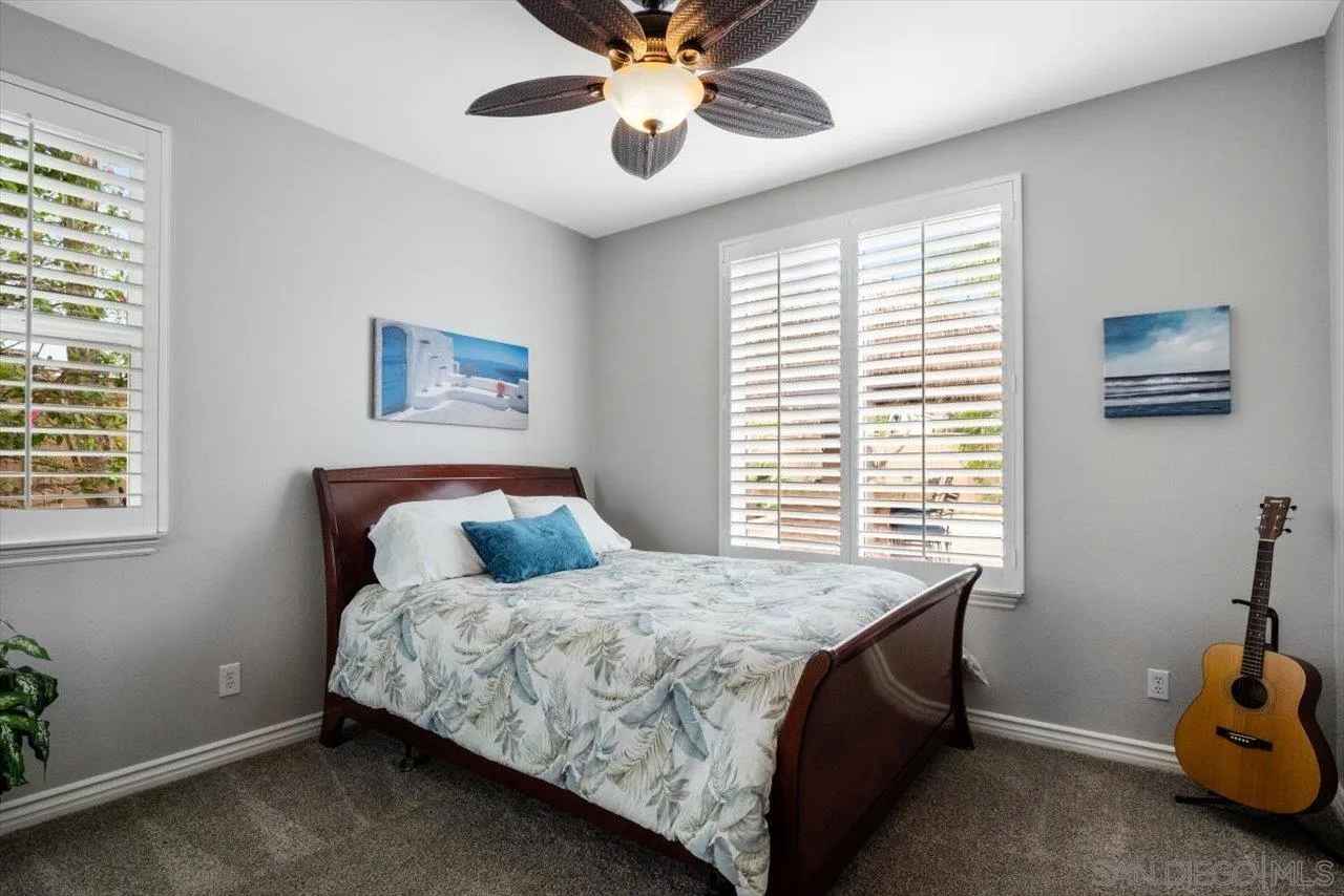 565 Hidden Trails Road Escondido, CA 92027 - Photo 24 of 52 a bedroom with a bed and window