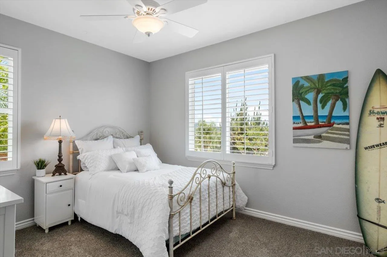 565 Hidden Trails Road Escondido, CA 92027 - Photo 39 of 52 a bedroom with a bed and a chandelier