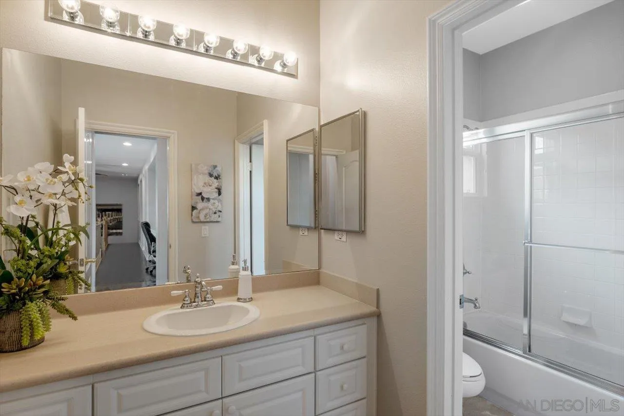 565 Hidden Trails Road Escondido, CA 92027 - Photo 40 of 52 a bathroom with a sink and a mirror