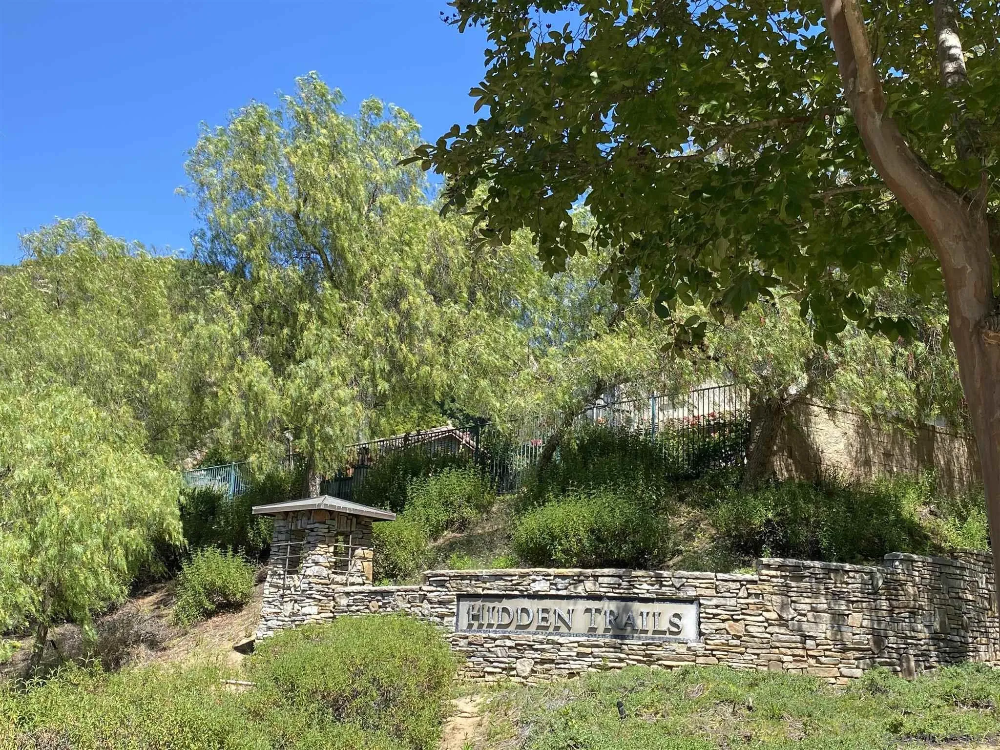 565 Hidden Trails Road Escondido, CA 92027 - Photo 49 of 52 a view of a lake with a bench