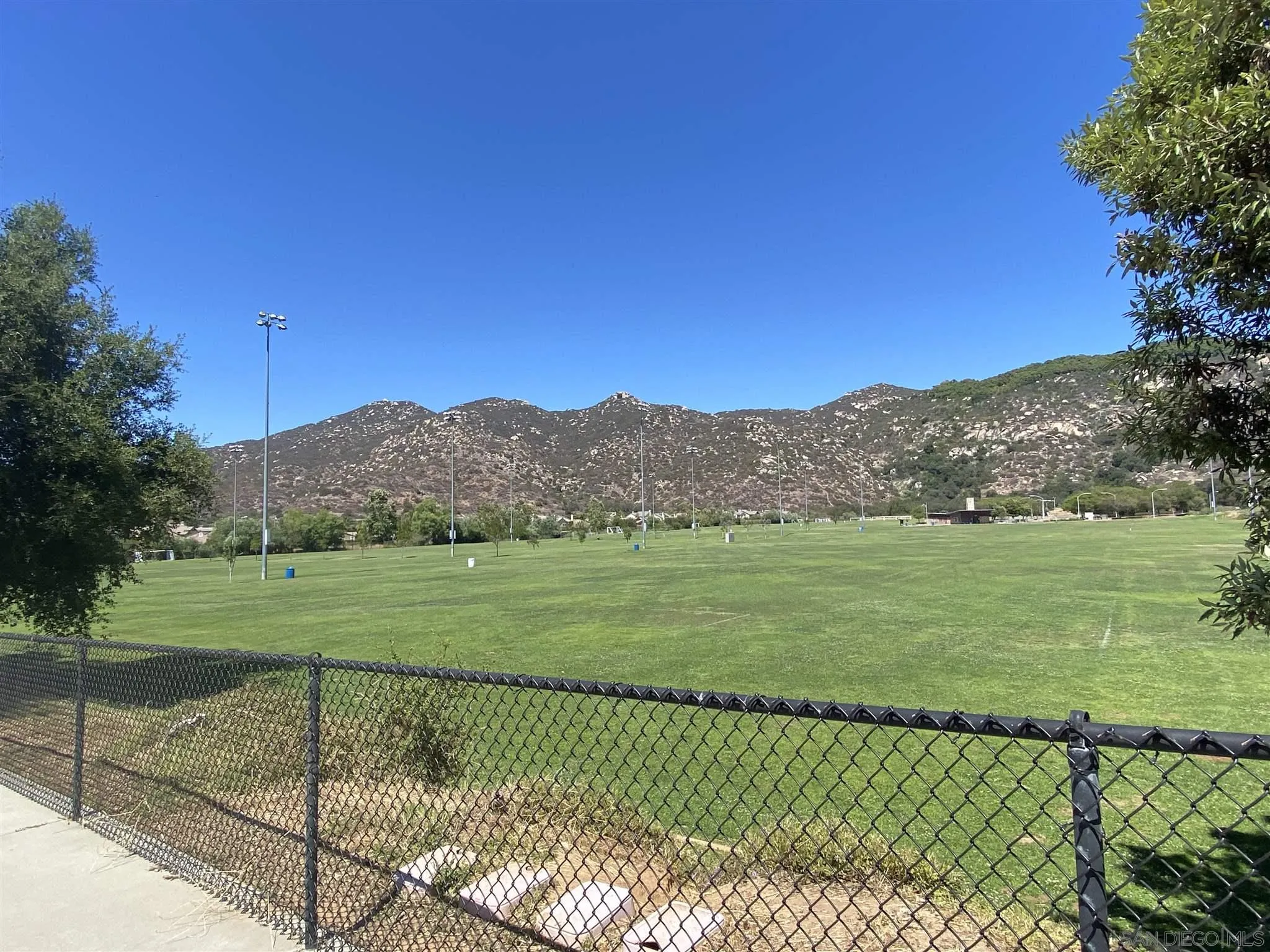 565 Hidden Trails Road Escondido, CA 92027 - Photo 50 of 52 a view of a grassy field with an trees