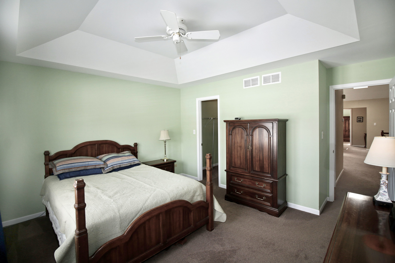 19213 Weber Road Mokena, IL 60448 - Photo 16 of 36 a bedroom with a bed and a chandelier