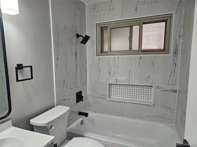 a bathroom with a toilet a sink and a bathtub