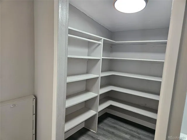 a view of walk in closet with empty racks