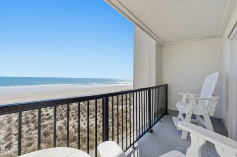 a balcony with table and chairs
