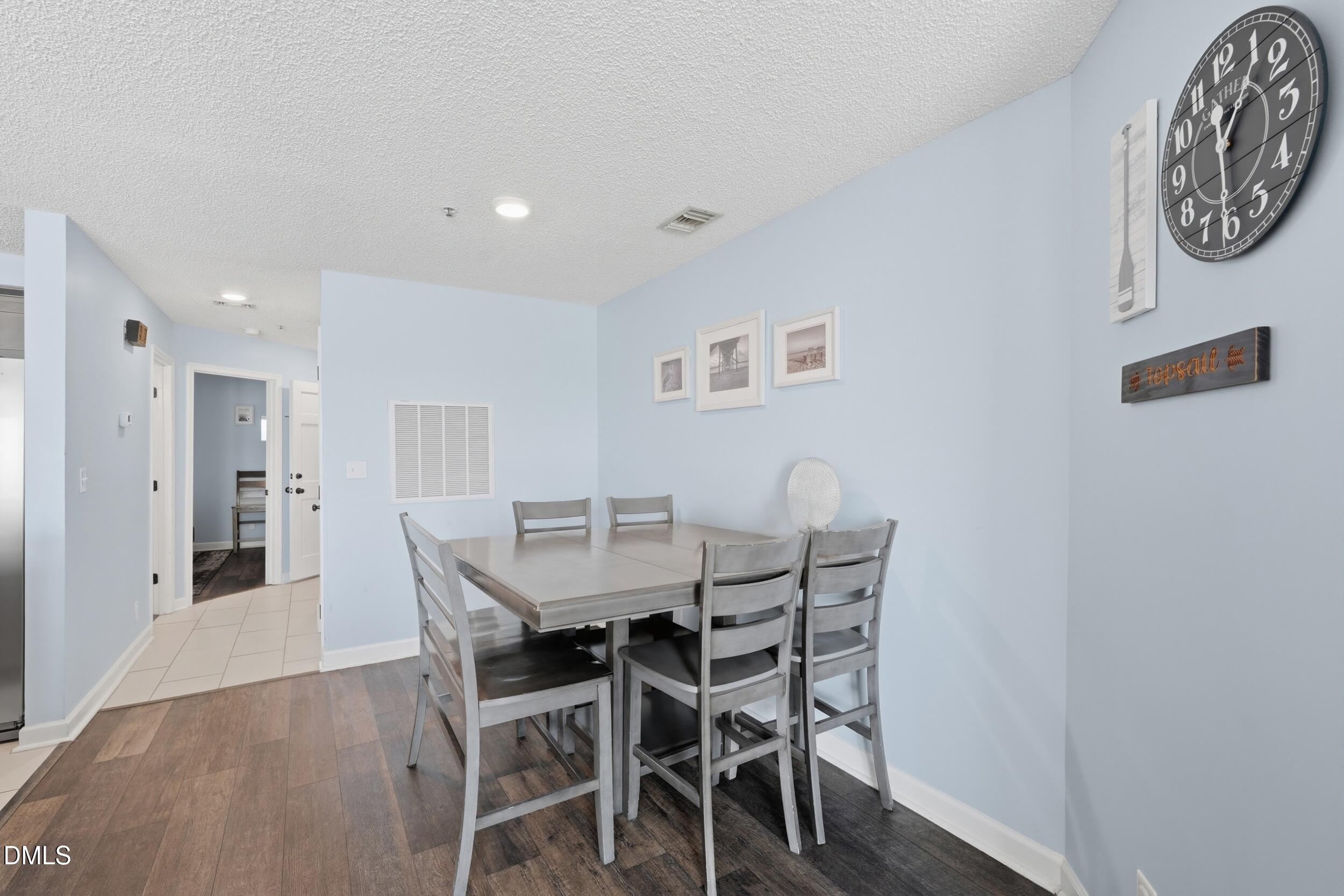 790 New River Inlet Road, Unit 114A North Topsail Beach, NC 28460 - Photo 14 of 46 a view of a dining room with furniture and a table