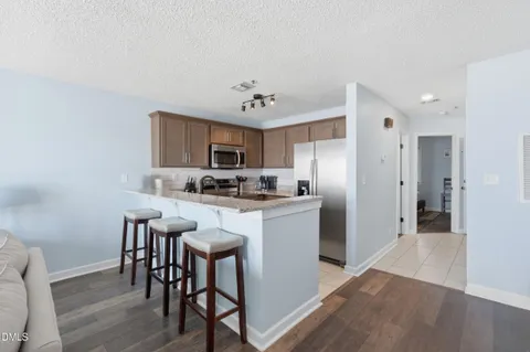 a kitchen with stainless steel appliances granite countertop a sink and a stove