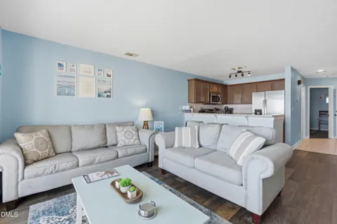 a kitchen with refrigerator a sink and chairs