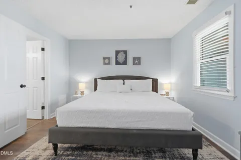 a bedroom with a bed and a night stand