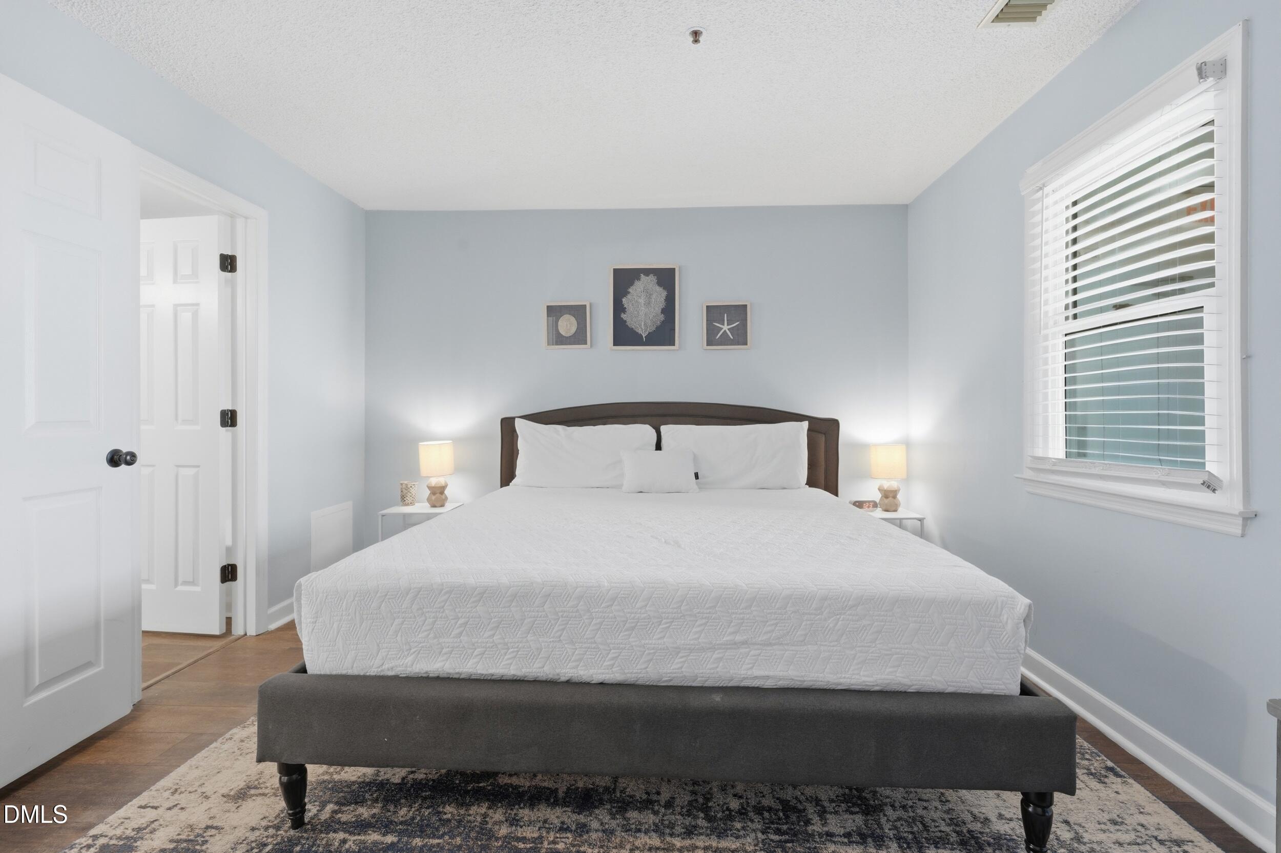 790 New River Inlet Road, Unit 114A North Topsail Beach, NC 28460 - Photo 29 of 46 a bedroom with a bed and window