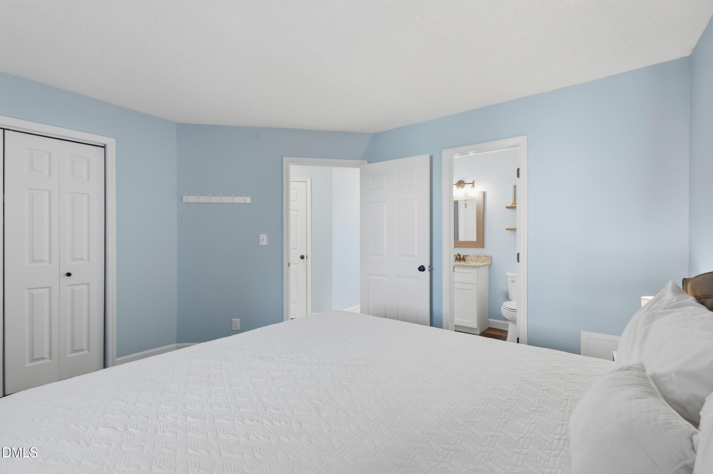 790 New River Inlet Road, Unit 114A North Topsail Beach, NC 28460 - Photo 30 of 46 a bedroom with a bed and a bathroom