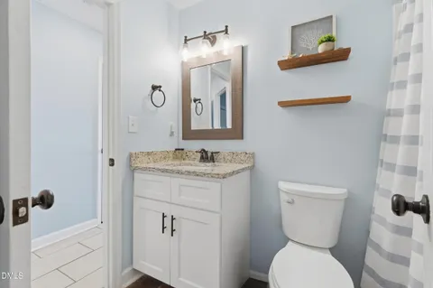 a bedroom with a bed and a bathroom
