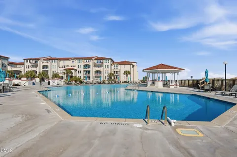 a view of a swimming pool with a chairs
