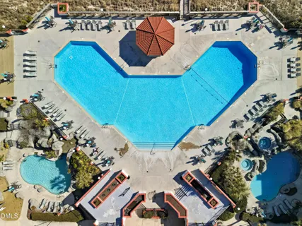 a view of swimming pool with outdoor seating and yard