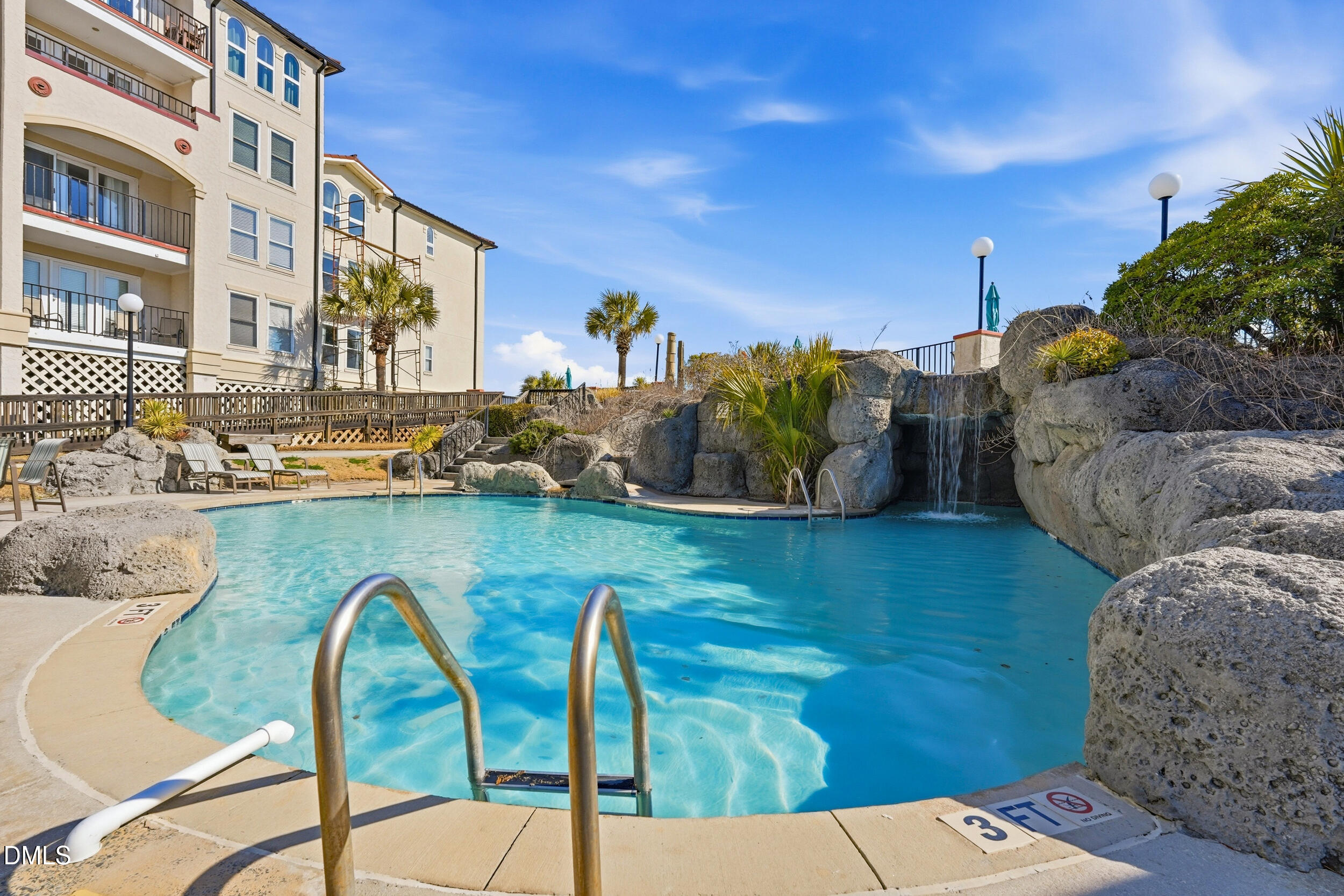 790 New River Inlet Road, Unit 114A North Topsail Beach, NC 28460 - Photo 43 of 46 a view of a swimming pool with outdoor seating and plants