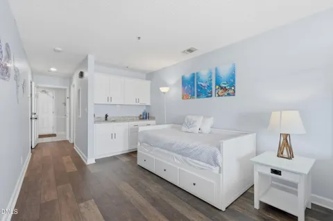 a bathroom with a tub shower and a sink