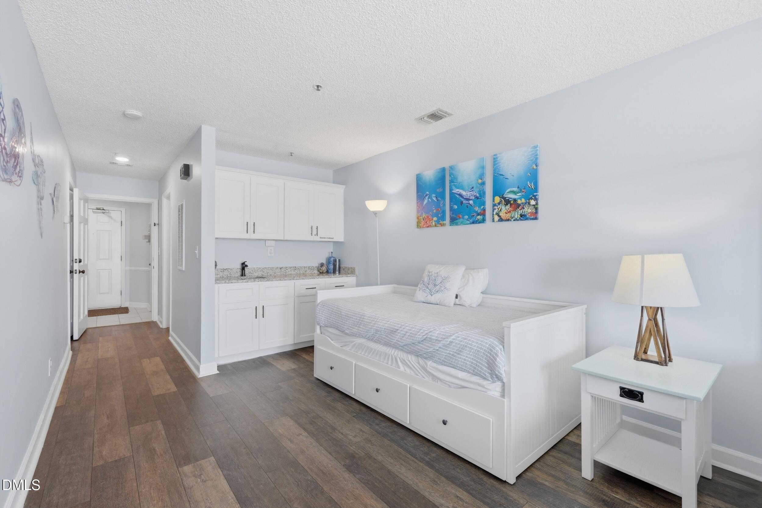 790 New River Inlet Road, Unit 114A North Topsail Beach, NC 28460 - Photo 4 of 46 a large white bed in a white room