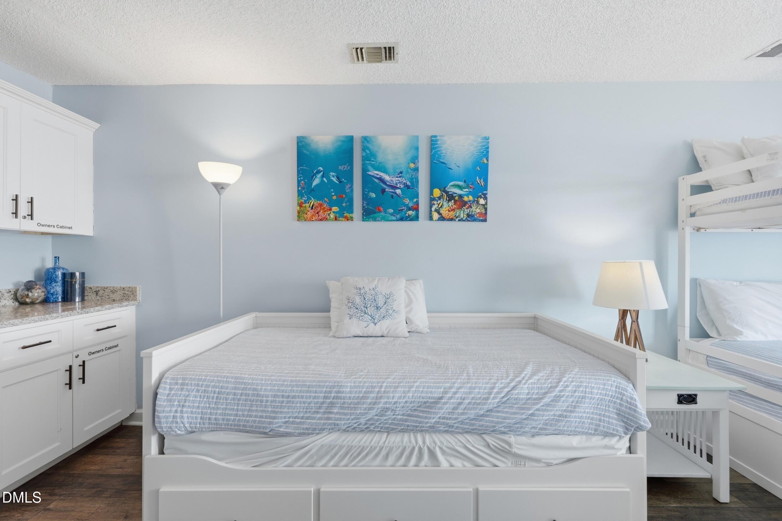 790 New River Inlet Road, Unit 114A North Topsail Beach, NC 28460 - Photo 5 of 46 a large white bed in a white room