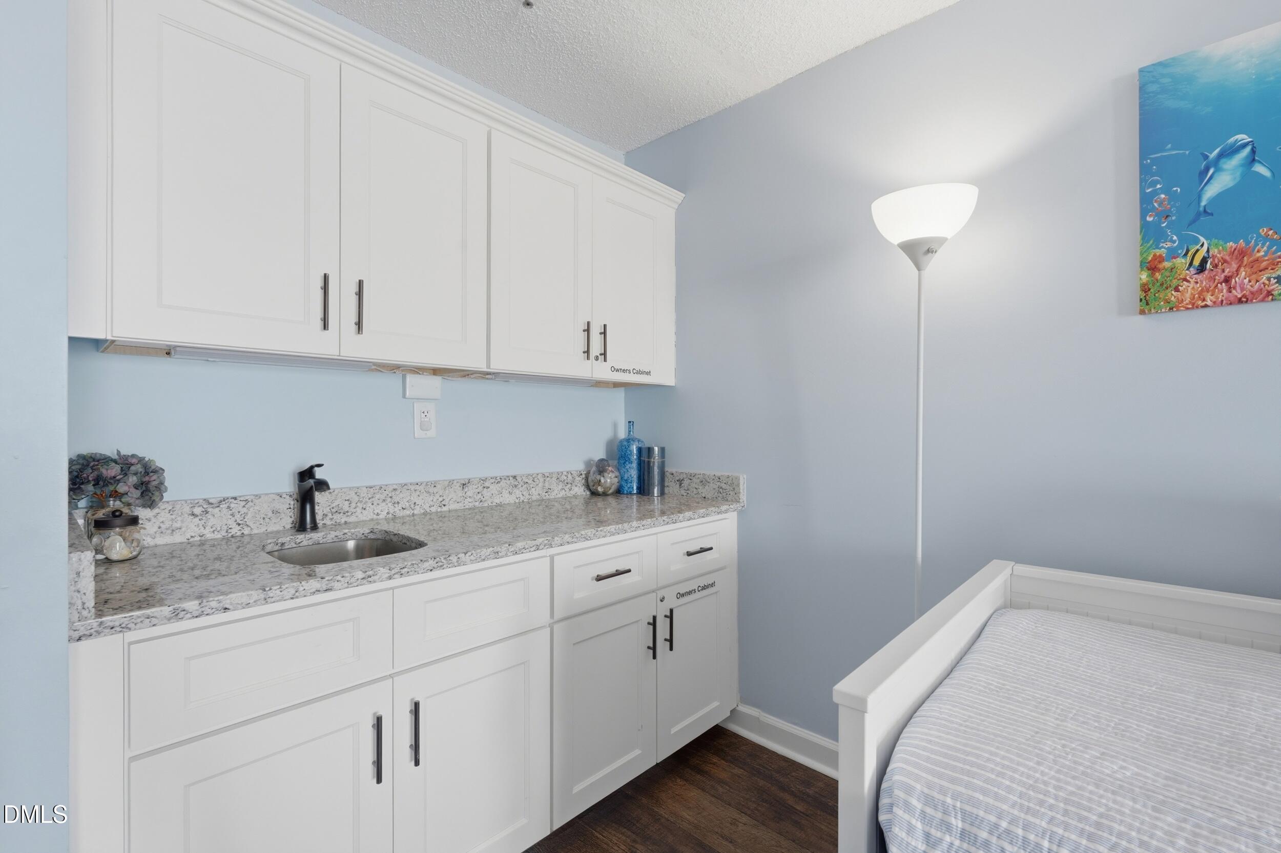 790 New River Inlet Road, Unit 114A North Topsail Beach, NC 28460 - Photo 6 of 46 a kitchen with a sink and cabinets