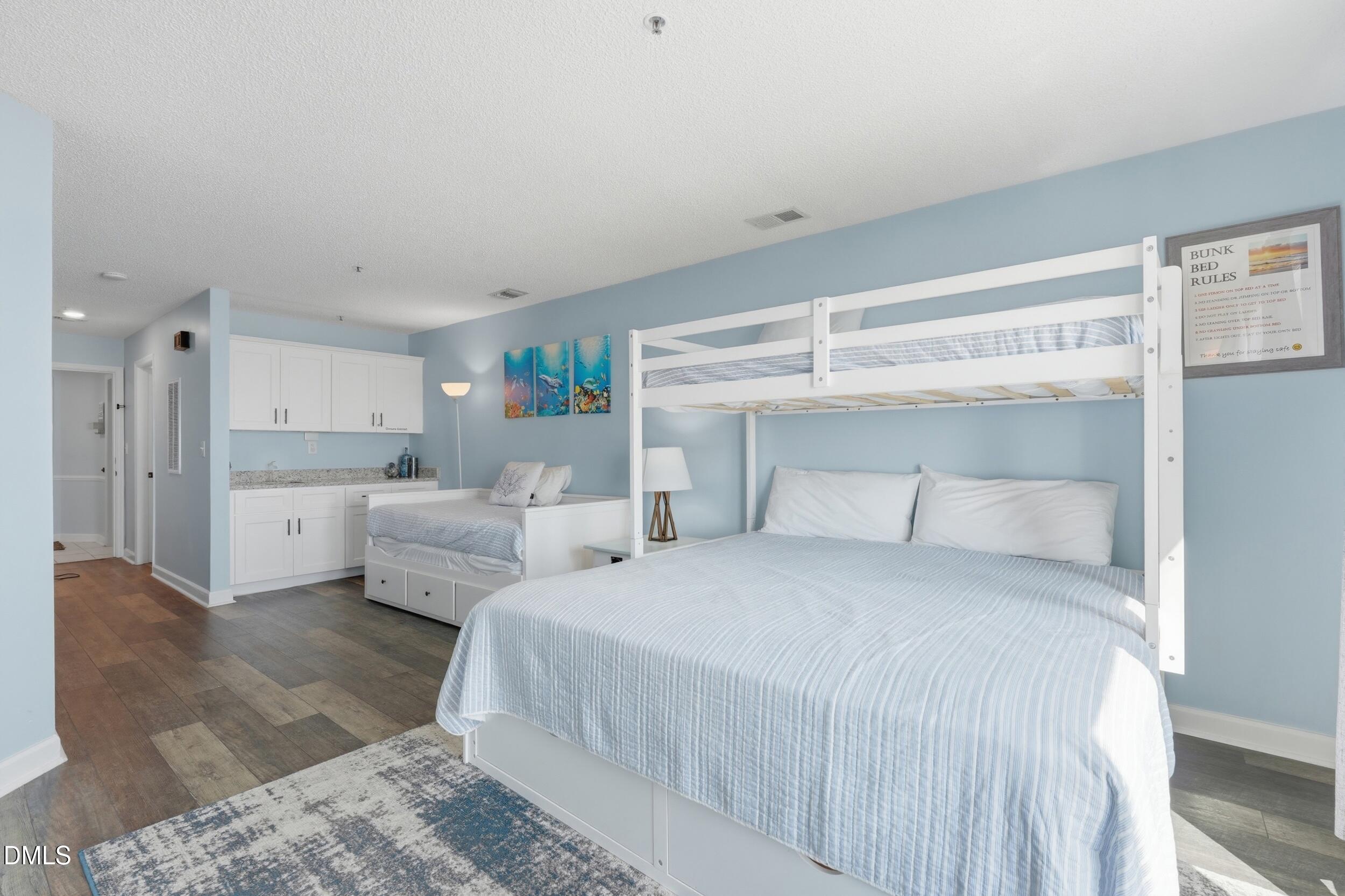 790 New River Inlet Road, Unit 114A North Topsail Beach, NC 28460 - Photo 8 of 46 a large white bed in a white room