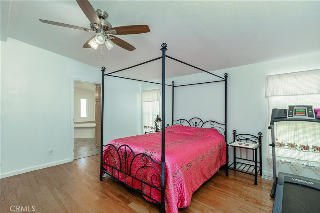 4905 Huasna Road Arroyo Grande, CA 93420 - Photo 14 of 59 a bedroom with a bed and a chandelier