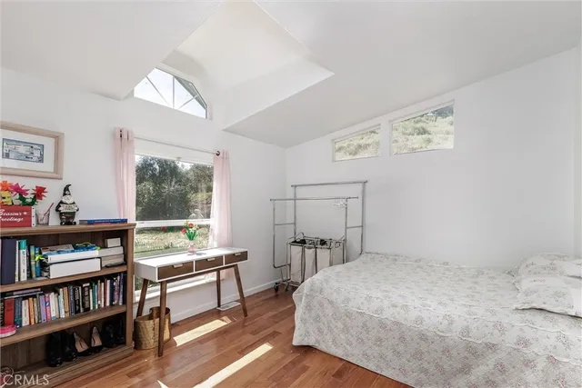 a bedroom with a bed and a book shelf