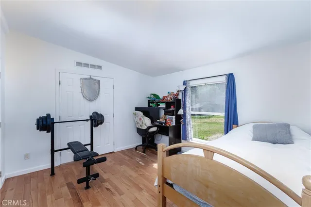 a bedroom with a bed a desk and chair