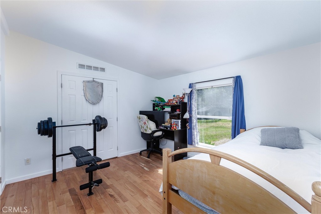 4905 Huasna Road Arroyo Grande, CA 93420 - Photo 19 of 59 a bedroom with a bed a desk and chair