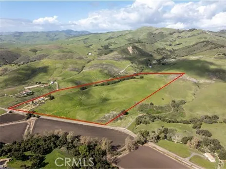 an aerial view of a houses with a yard