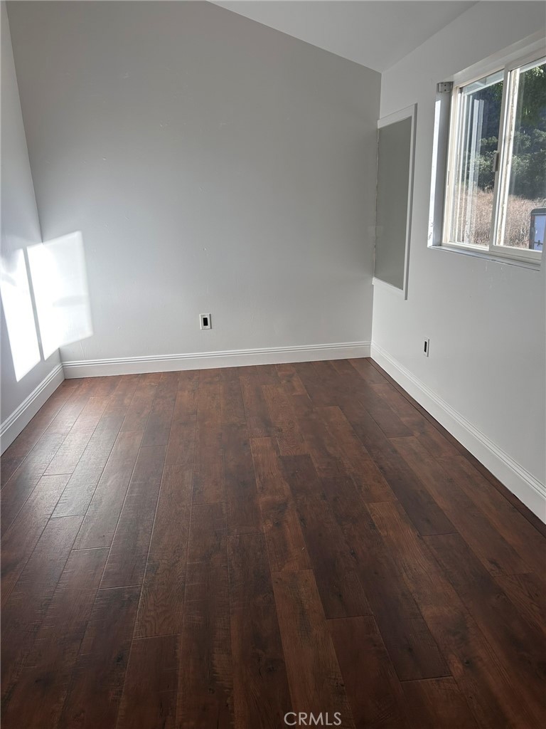 4905 Huasna Road Arroyo Grande, CA 93420 - Photo 34 of 59 an empty room with wooden floor and windows