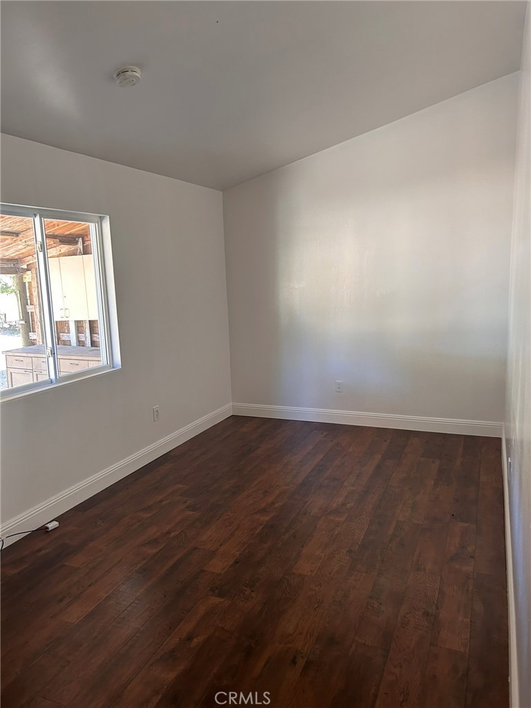 4905 Huasna Road Arroyo Grande, CA 93420 - Photo 35 of 59 an empty room with wooden floor and windows
