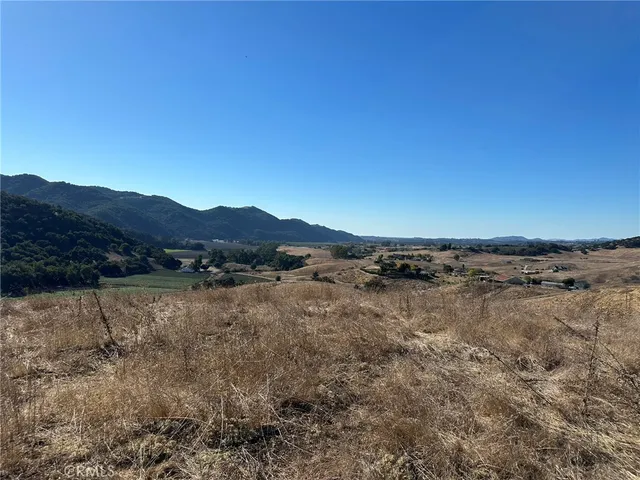 a view of a swimming pool with a table & chairs