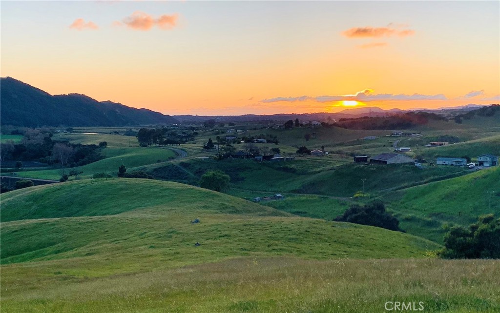 4905 Huasna Road Arroyo Grande, CA 93420 - Photo 58 of 59 a view of a grassy field with mountains in the background