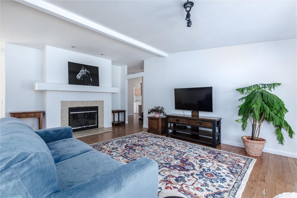 4905 Huasna Road Arroyo Grande, CA 93420 - Photo 7 of 59 a living room with furniture a fireplace and a flat screen tv