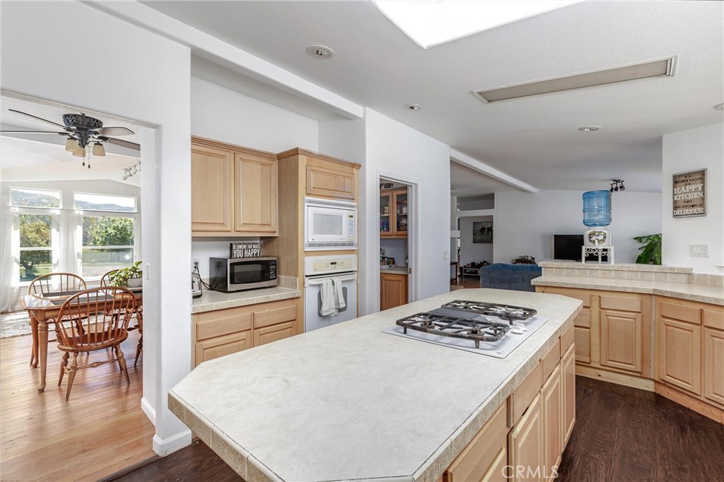4905 Huasna Road Arroyo Grande, CA 93420 - Photo 9 of 59 a kitchen with a stove a refrigerator and wooden floor