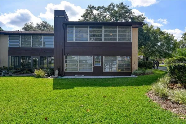 an aerial view of a house with a yard and lake view