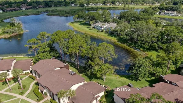 an aerial view of a house with garden space and swimming pool