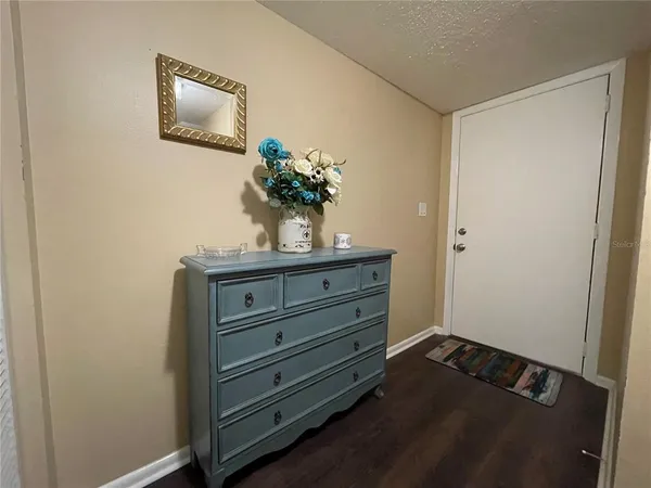 a view of room with wooden floor