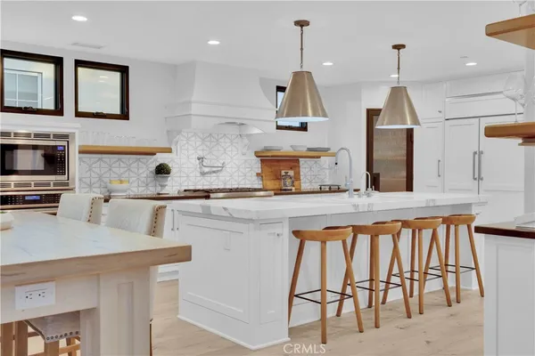 a kitchen with a table chairs sink and cabinets