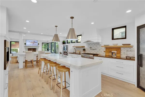 a large kitchen with a large counter top appliances and cabinets