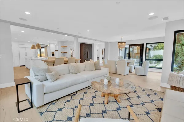 a living room with furniture and a painting on the wall