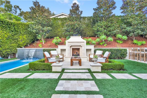 a view of a house with garden and a bench