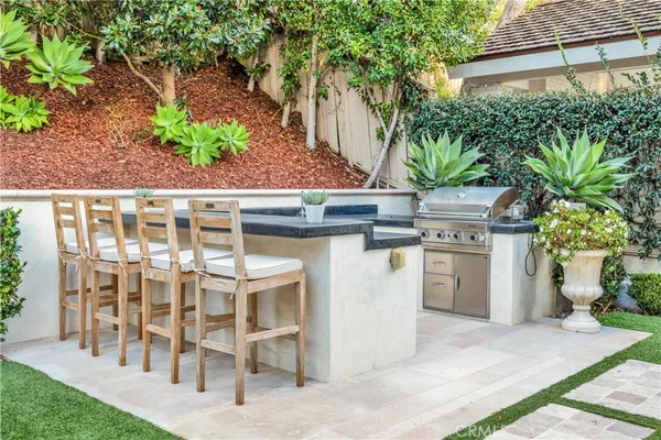 a view of a chairs and table in the back yard of the house