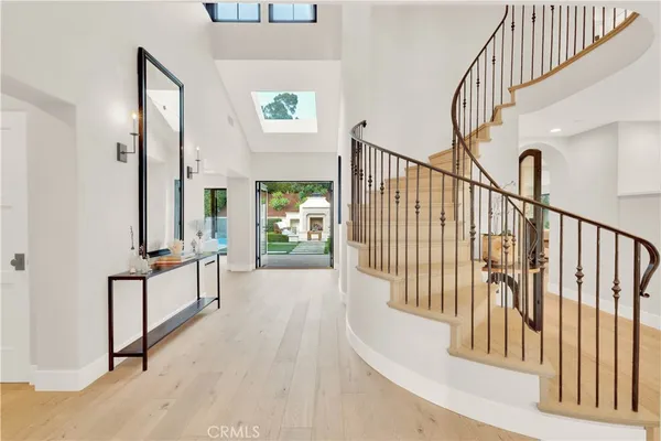a view of staircase with lots of frames on wall and a large window